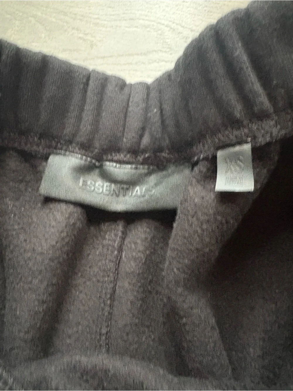 Fear of God ESSENTIALS Black Tee with Cream Hang Tag